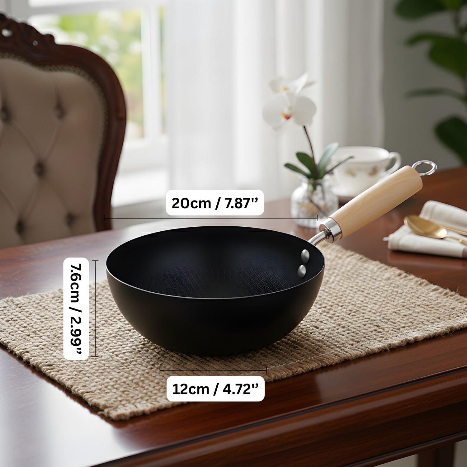 Black wok with wooden handle on a table with measurements displayed